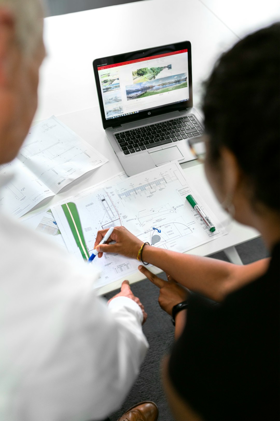 Female civil engineer discusses flood risk management plans with colleague
